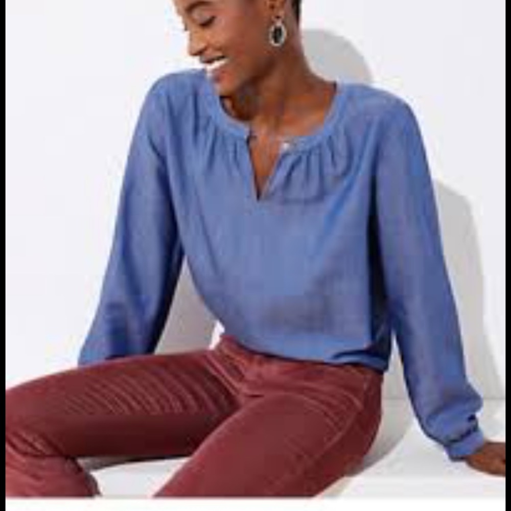Long sleeve blue SP Loft shirt. Eyelet button.